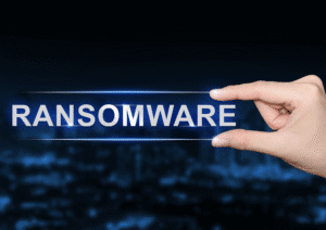 Ransomware Attacks: Protecting Your Business from the Growing Threat 1 a hand holding a sign